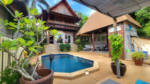 a house with a swimming pool in front of a house at Villa Ayutthaya, Private Pool Near Kantiang Beach in Ko Lanta +27 photos