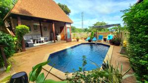 a swimming pool in the backyard of a house at Villa Ayutthaya, Private Pool Near Kantiang Beach in Ko Lanta
