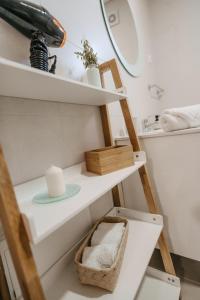 a bathroom with a shelf with a toilet and a sink at Houses São Pedro in São João da Pesqueira +40 photos