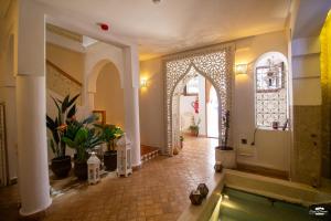 a hallway with a pool in a building with a room with at Riad Nila in Chefchaouen +124 photos