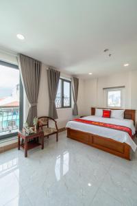 a bedroom with a large bed and a large window at Apogee Hotel in Ho Chi Minh City +52 photos
