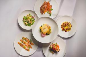 a group of white plates of food on a table at The Shepherd Mayfair in London