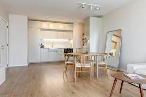 a kitchen and living room with a table and chairs at Dalia Residence - Boutique Apartment in Sofia