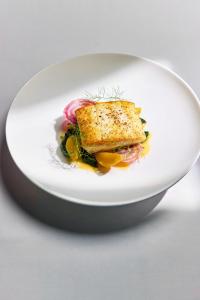 a white plate with a piece of food on it at The Shepherd Mayfair in London +38 photos