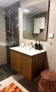 a bathroom with a sink and a mirror and a shower at Sea Side House Kourouta in Kourouta +42 photos