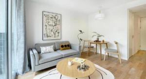 a living room with a couch and a table at base-WENDING Service Apartment-Shanghai Xujiahui Location in Shanghai