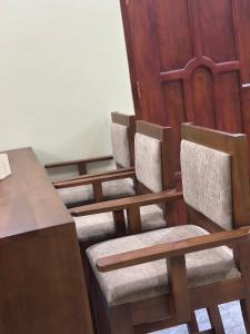 a row of chairs in a room with a table at Ecostar apartments in Morogoro