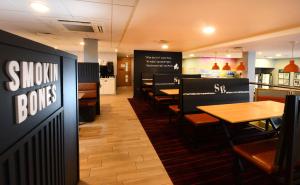 a dining room with tables and chairs in a restaurant at Travelodge Plus Galway in Galway