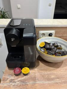 a coffee maker on a counter next to a bowl at Ferienwohnung Noela in Sankt Ingbert +21 photos