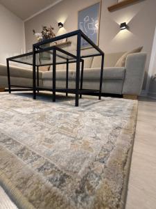 a living room with a couch and a glass table at Ferienwohnung Noela in Sankt Ingbert
