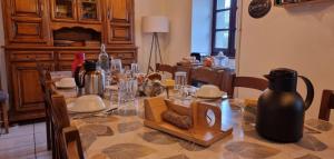 a dining room with a table with a vase on it at La Cantalienne du Saladou in Mont-Chanson