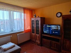 a living room with a flat screen tv and a window at Apartman National 2 in Velika Kladuša