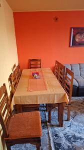 a dining room with a wooden table and chairs at Apartman National 2 in Velika Kladuša