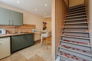 a kitchen with a staircase with wine bottles in a kitchen at L'inavouable Love-room Jacuzzi in Marquise