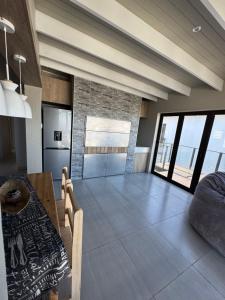 a kitchen and dining room with a table and chairs at Oceanview Stays in Great Brak River