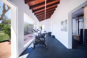 a room with a gym with exercise bikes on the floor at Serenity Apartments in Port d'Alcudia