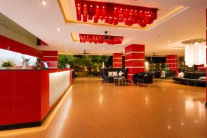 a lobby of a hotel with red accents at Nova Platinum Hotel in Pattaya South +41 photos