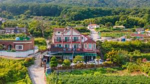 an aerial view of a house in a village at Geoje Araon Pension in Geoje