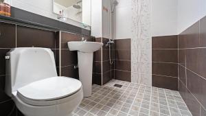 a bathroom with a toilet and a sink at Geoje Araon Pension in Geoje +63 photos