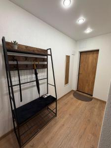 a room with a bunk bed with an umbrella at Bright & Brand New Appartment in Liepāja