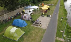 a group of tents on the grass next to a street at Bycicle camp - Český Bufík in Horní Počaply