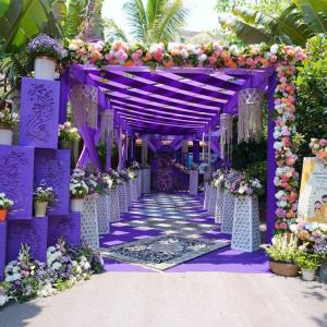 a purple archway with flowers and plants at dashupunit in Pushkar