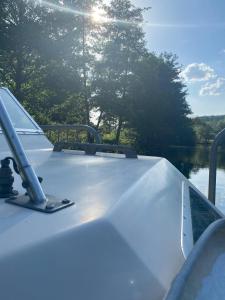 a boat on a lake with the sun shining on it at Petit Shetland in Liverdun