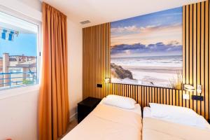 a bedroom with two beds and a picture of the beach at Breathtaking Penthouse Las Azaleas in Torrox +37 photos