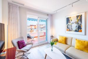 a living room with a couch and a window at Breathtaking Penthouse Las Azaleas in Torrox