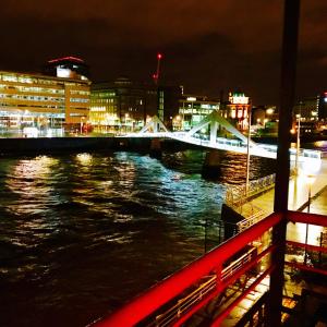 a bridge over a river in a city at night at Glasgow City Centre Flat with River Views and Parking in Glasgow