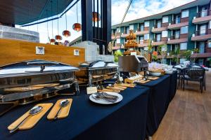 a long table with food on it in front of a building at Wing 4203 - Modern Resort Studio Koh Samui in Bophut