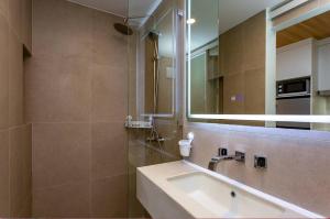 a bathroom with a sink and a mirror at Wing 4203 - Modern Resort Studio Koh Samui in Bophut +2 photos