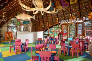 a room with colorful tables and chairs in a store at Niva Kuramathi Maldives in Rasdhoo