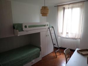 a small room with a bunk bed and a ladder at Nidus in Aulla