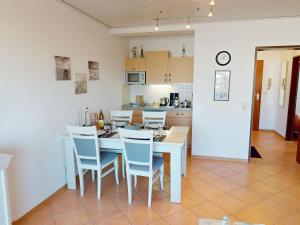 a kitchen and dining room with a table and chairs at Rotesand - 117 in Cuxhaven