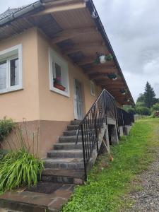 a house with stairs leading up to a porch at La Elias in Breb