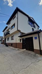 a building with two garage doors on a street at Apartment Fortuna in Visoko