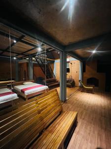 two beds in a room with benches and a staircase at Misty Haven A-Frame in Kandy