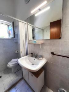 a bathroom with a sink and a toilet at Quirino Residence in Gaeta +84 photos