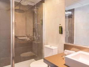a bathroom with a shower and a toilet and a sink at Ona Palmira Paguera in Paguera +47 photos
