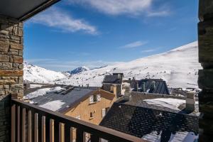 a view of a snowy mountain from a balcony at Estival Caribou in Pas de la Casa