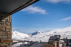 a view of a snowy mountain from a building at Estival Caribou in Pas de la Casa
