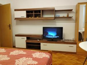 a living room with a flat screen tv on a desk at inKorcula in Korčula