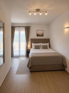 a bedroom with a large bed in a room at VN Lux Apartments in Prijevor