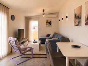 a living room with a couch and a table at VN Lux Apartments in Prijevor