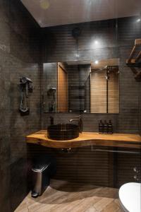 a bathroom with a sink and a mirror at Lens Design Hotel in Kazbegi +29 photos