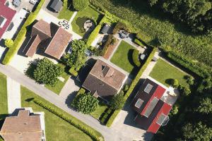 an overhead view of a yard with houses and trees at The Cosy Cottage - Comfort Sauna & Hot Tub in Private Garden in Zeewolde