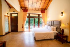 a bedroom with a white bed and a large window at Riverdale lagoon villas in Aluthgama +103 photos