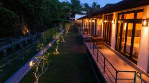 a balcony of a building at night with lights at Riverdale lagoon villas in Aluthgama