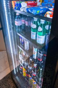 a refrigerator filled with lots of bottles of water at Hotel Vasanta in Barcelona